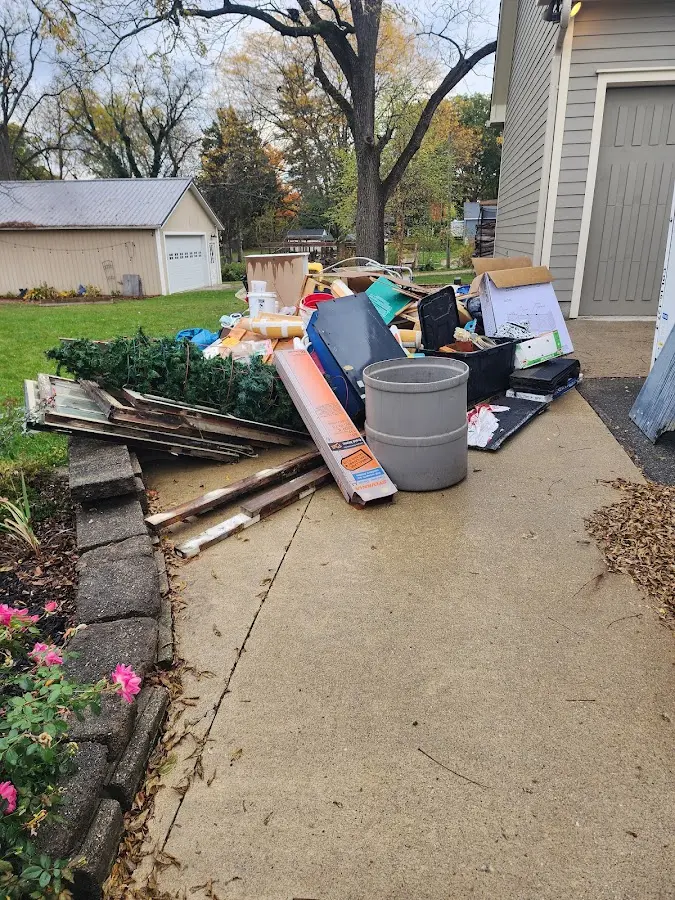 Dumpster being loaded with debris for Residential Dumpster Rental in Westfield